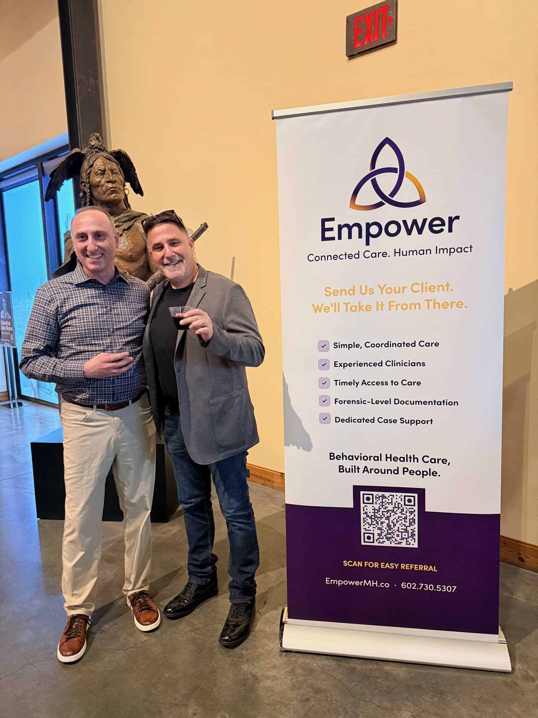Empower Chief Growth Officer Anthony Conti with Steve Giunta of KTAR beside an Empower banner