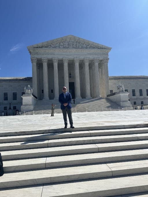 Dr. Loeb standing on the steps of the United States Supreme Court